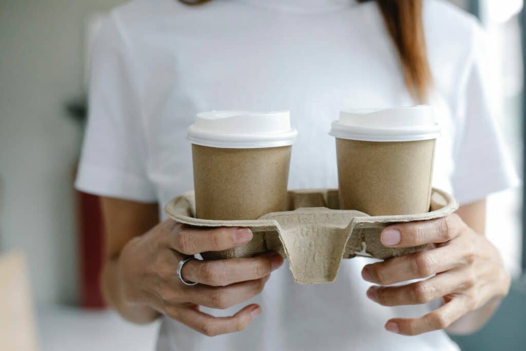 woman holding cups of coffee
